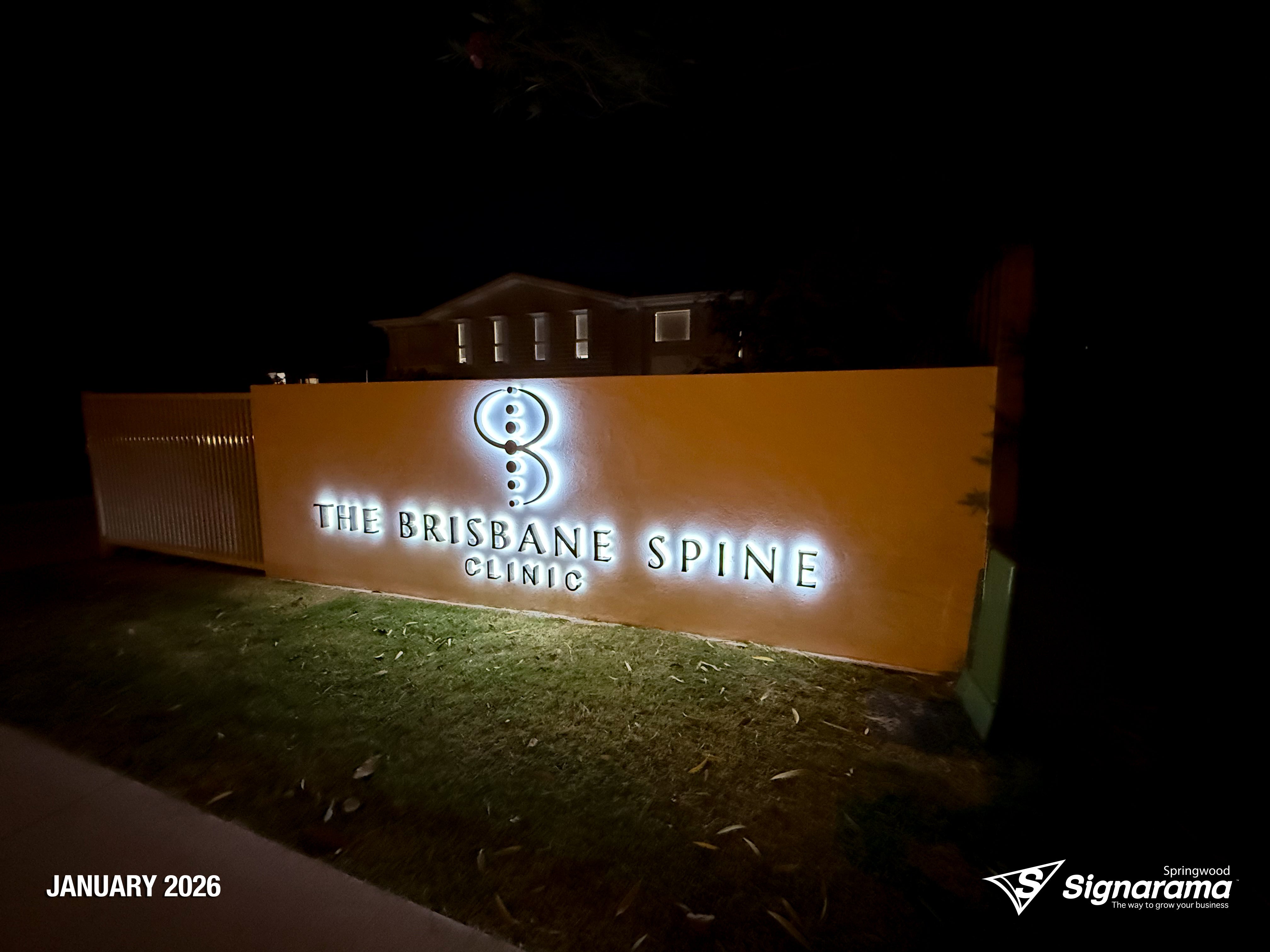 Halo-lit stainless steel letters and 2-Pak sprayed logo installed by Signarama for Brisbane Spine Clinic.