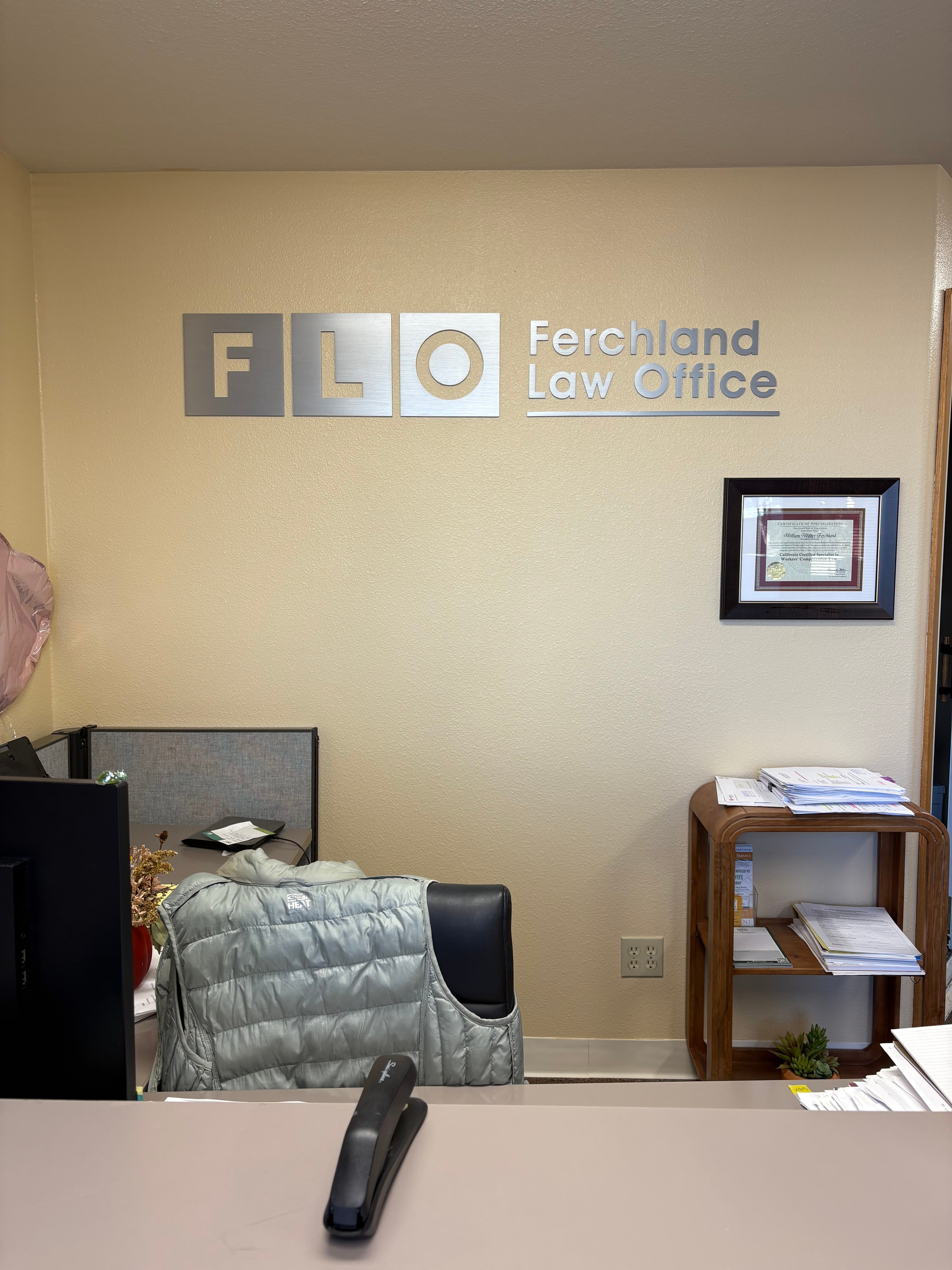 Brushed stainless steel dimensional lettering on a lobby wall