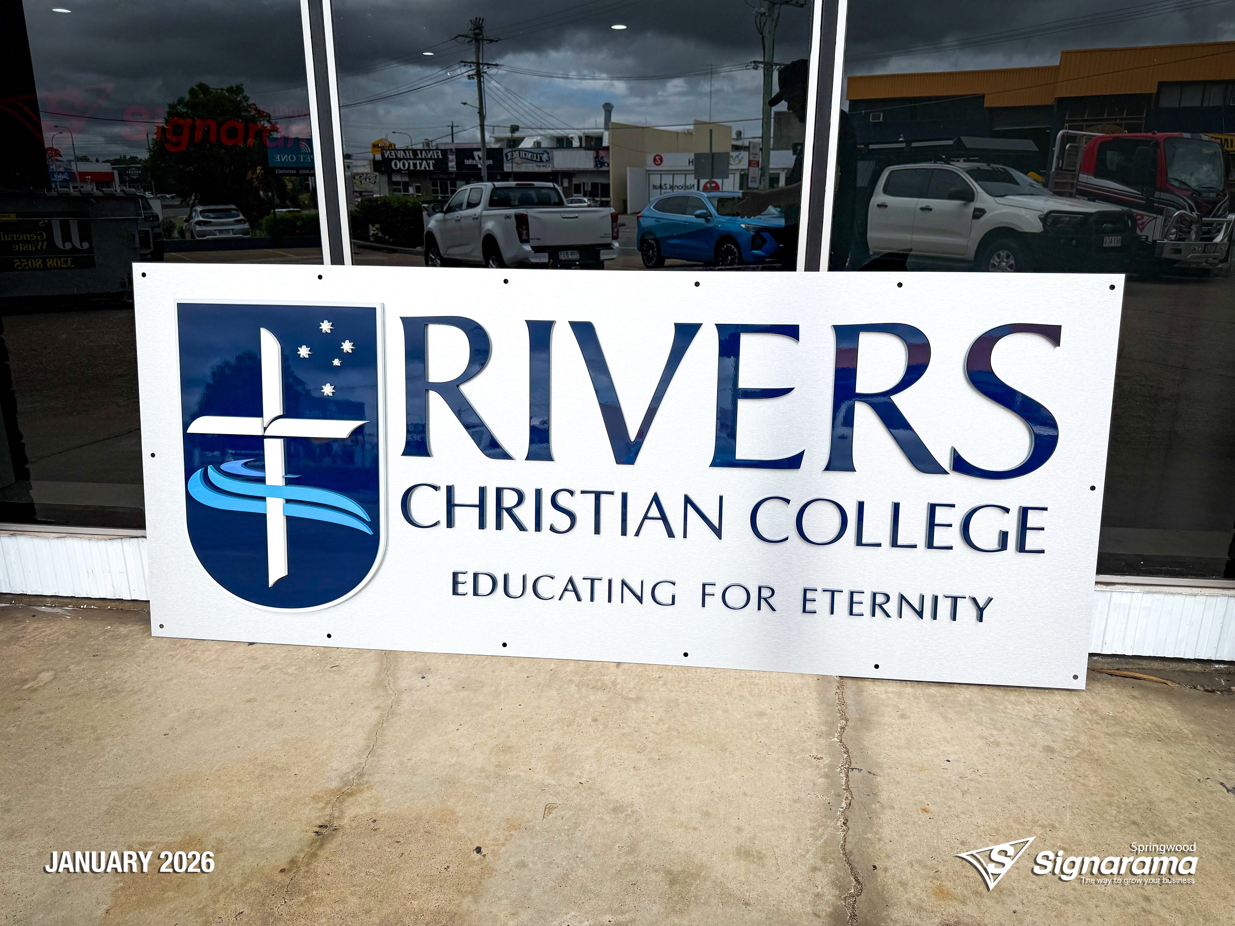 3D acrylic logo signage installed at Rivers Christian College by Signarama Springwood, featuring clean, modern dimensional lettering for a professional school reception display.