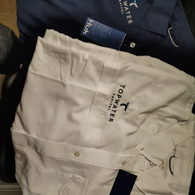 https://cdn.gorilladash.com/images/media/20365708/fully-promoted-usa-topwater-capital-huk-shirts-square-698f71b438358.png?auto=webp&crop=1%3A1%2Csmart&width=400