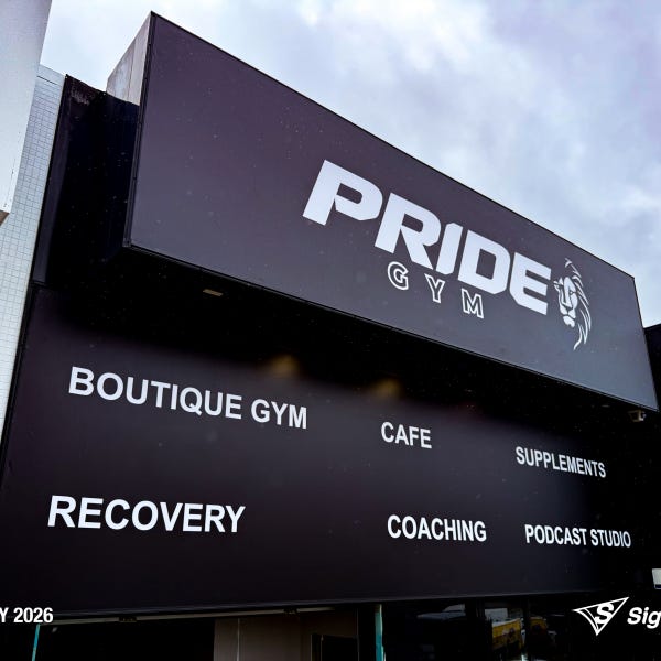 Large storefront sail track banners installed at Pride Gym by Signarama Springwood, featuring bold, high-impact graphics stretched tightly across the building façade to create stro...