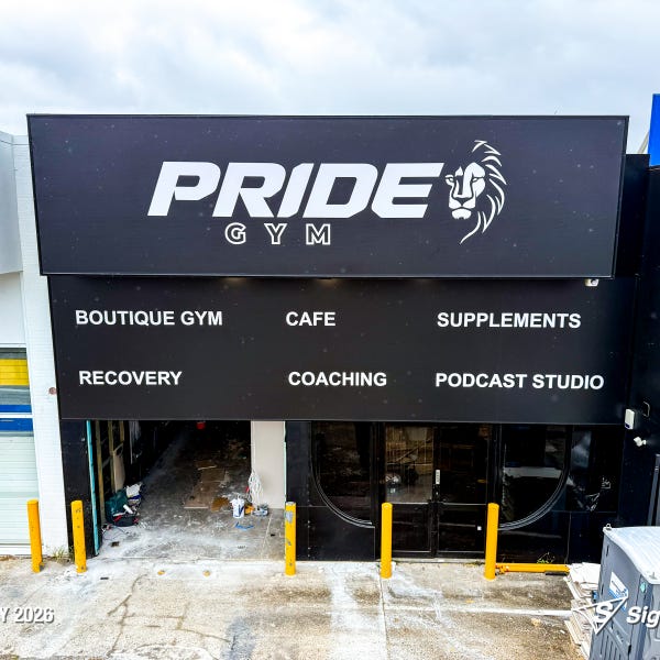 Large storefront sail track banners installed at Pride Gym by Signarama Springwood, featuring bold, high-impact graphics stretched tightly across the building façade to create stro...