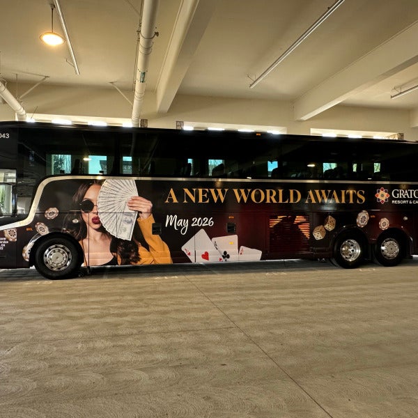 Passenger-side view of a Graton Casino branded bus wrap
