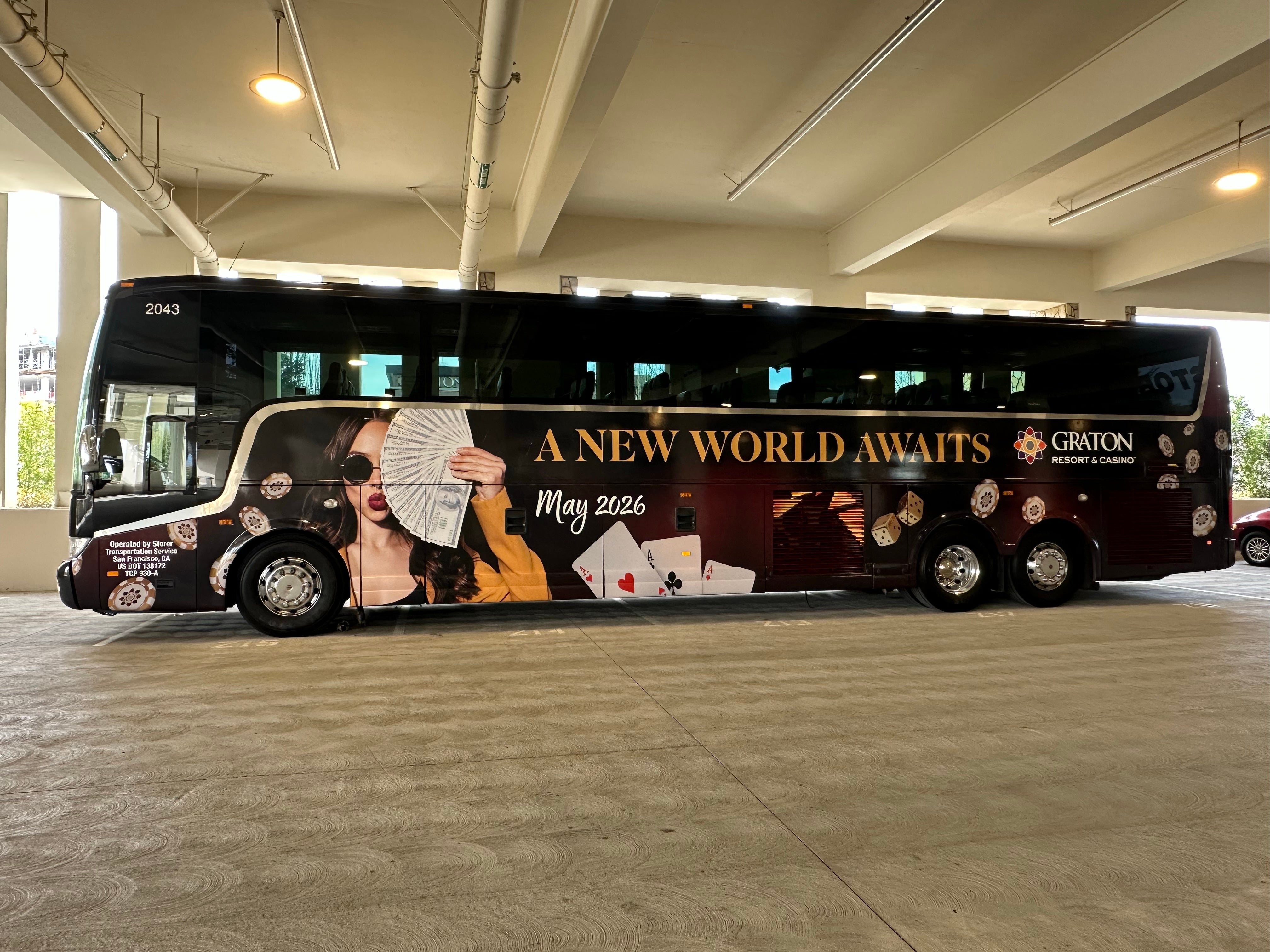 Passenger-side view of a Graton Casino branded bus wrap