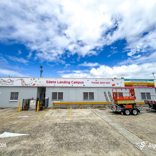 Replaced building signage installed by Signarama Springwood for Day One Edens Landing after hail damage, featuring new durable exterior signage on a commercial building in Queensla...