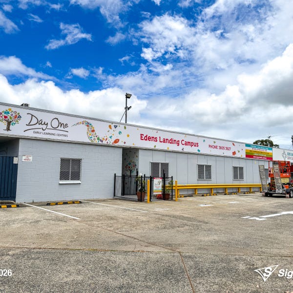 Replaced building signage installed by Signarama Springwood for Day One Edens Landing after hail damage, featuring new durable exterior signage on a commercial building in Queensla...