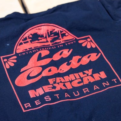https://cdn.gorilladash.com/images/media/20661485/fully-promoted-usa-la-costa-family-mexican-restaurant-branded-tshirt-fully-promotedjpg-square-69c2e2b352f7a.jpg?auto=webp&crop=1%3A1%2Csmart&width=400