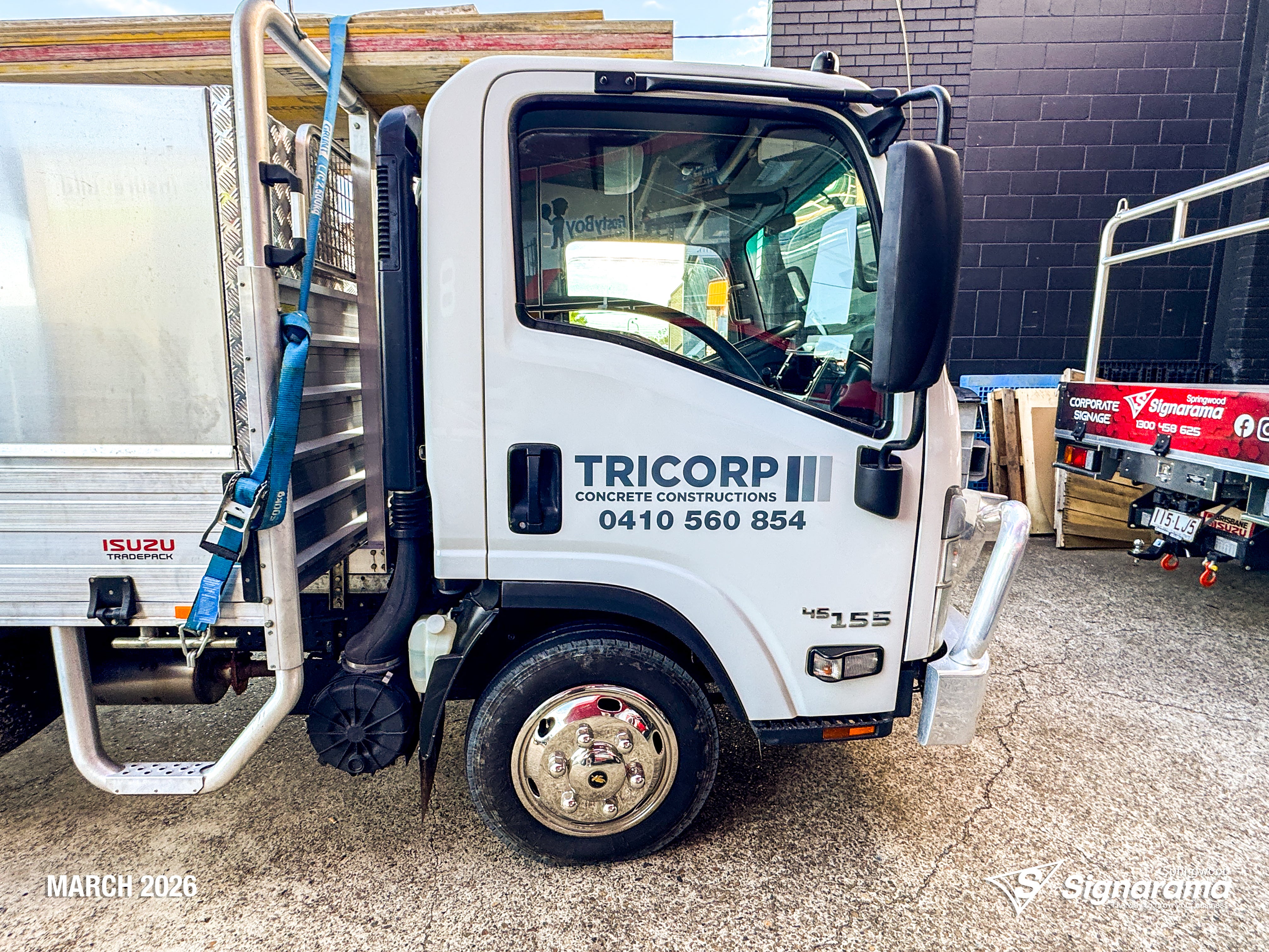 Signarama Springwood truck door vehicle graphics installed for Tricorp Concrete Constructions, featuring professional business branding on a work truck for mobile advertising.