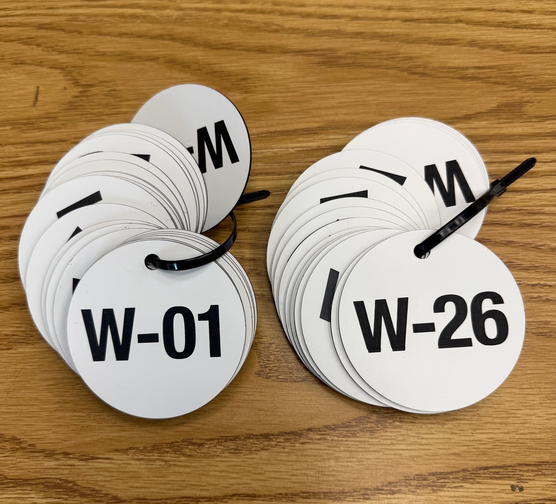 Round White Lamacoid Discs for Larlyn Prop Management in Edmonton, AB