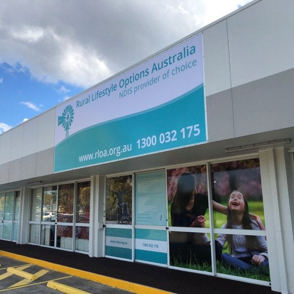 Full Signage solution. Sail Track Banner fascia sign with One Way Vision and high gloss Vinyl Window Graphics.