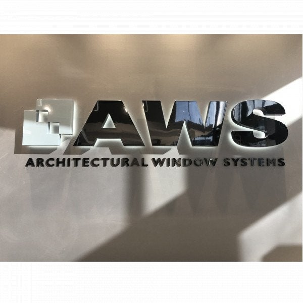 Stainless metal sign with chrome mirror finish | grey wall with halo lighting around letters. | Signarama