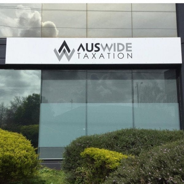 Metal Sign for tax accountants. The sign is white with black and grey branding. | Signarama
