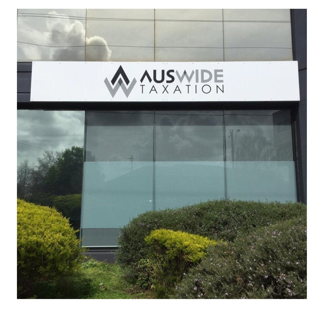 Metal Sign for tax accountants. The sign is white with black and grey branding. | Signarama