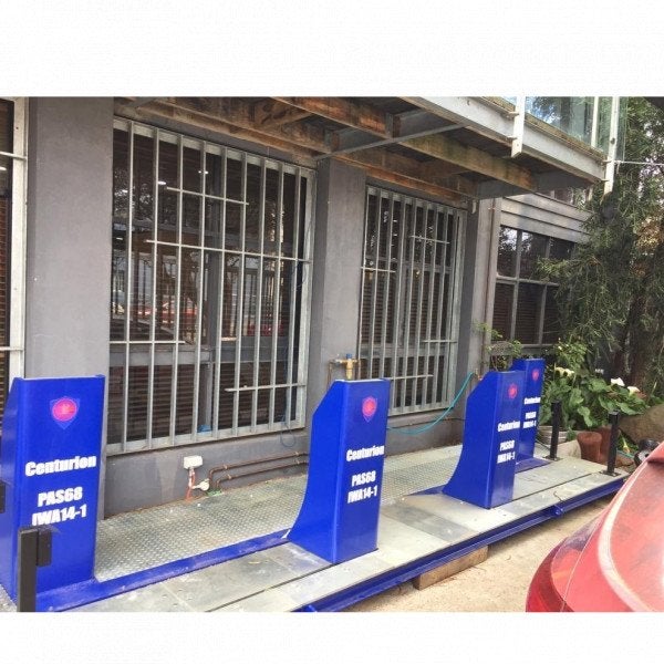 4 bollards covered up with blue bollard cover signs showcasing advertising opportunities | Bollard Signs