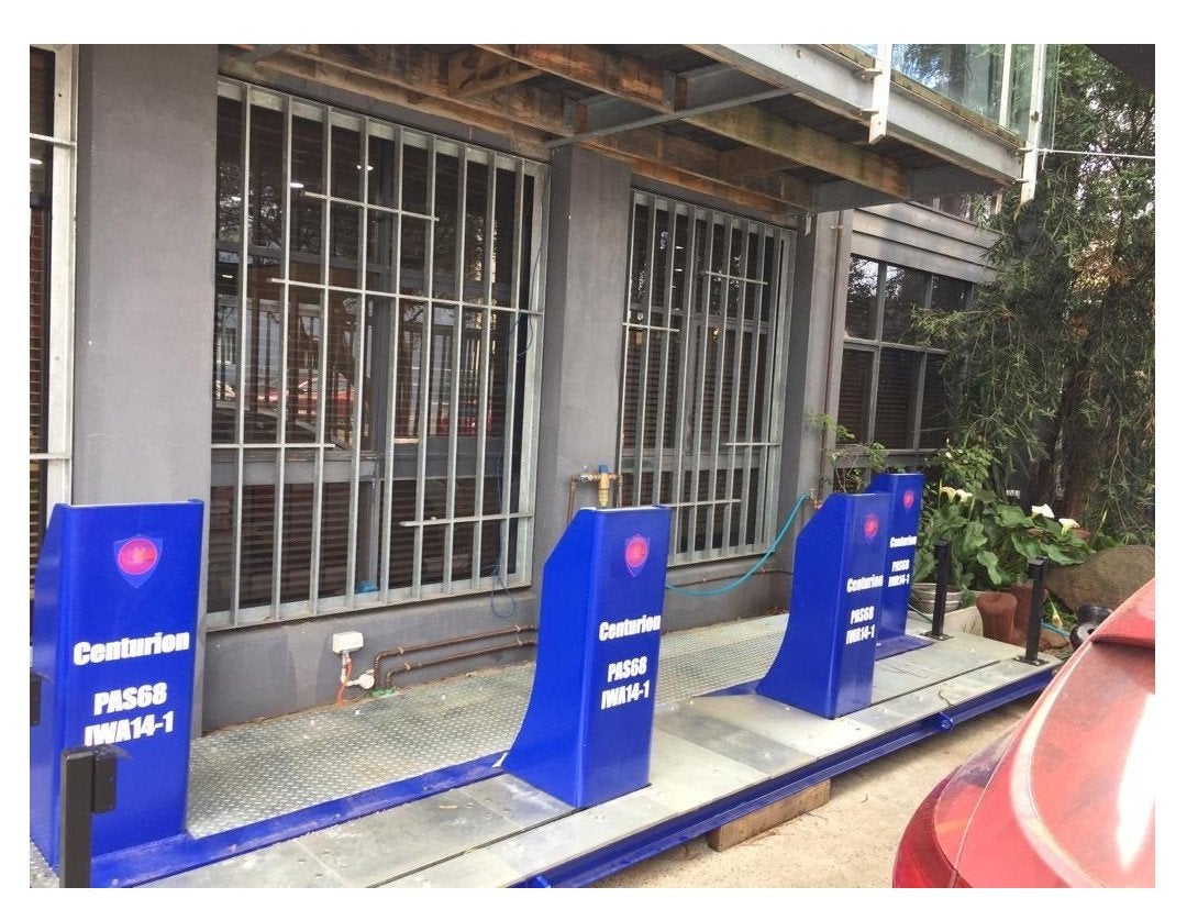 4 bollards covered up with blue bollard cover signs showcasing advertising opportunities | Bollard Signs
