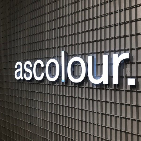 3D Illuminated letters for a business in white on a dark detailed background. | Signarama