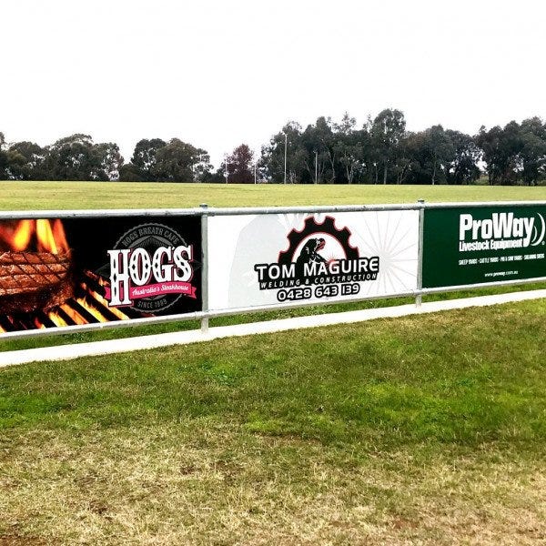 Vinyl Banner located on an outdoor fence advertising. | Signs by Signarama