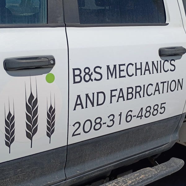 Branded service truck with bold logo and contact decal