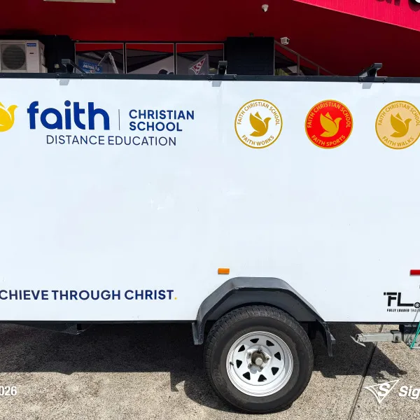 Trailer graphics installed by Signarama Springwood for Faith Christian School, featuring bold, professional vinyl graphics applied to a trailer for mobile branding and increased vi...