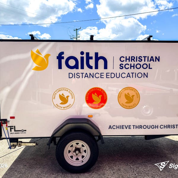 Trailer graphics installed by Signarama Springwood for Faith Christian School, featuring bold, professional vinyl graphics applied to a trailer for mobile branding and increased vi...