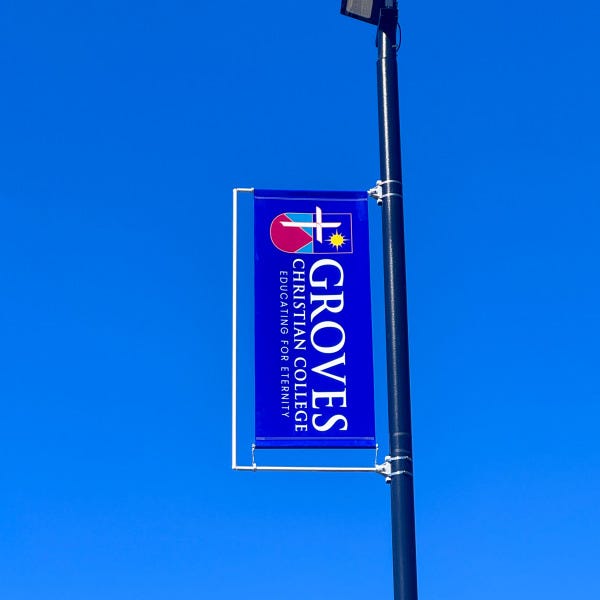 Carpark pole flags installed at Groves Christian College by Signarama Springwood, showcasing tensioned outdoor flags designed for clear visibility and durability
