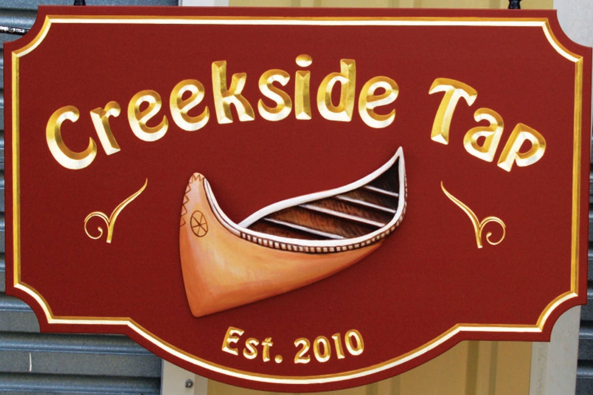 Red carved wooden sign