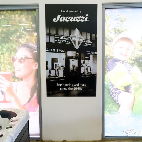 Banners and front door graphics designed and installed by Signarama Springwood for Spa World Underwood, refreshing storefront signage with modern branding