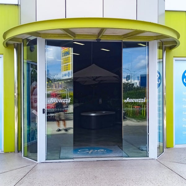 Banners and front door graphics designed and installed by Signarama Springwood for Spa World Underwood, refreshing storefront signage with modern branding