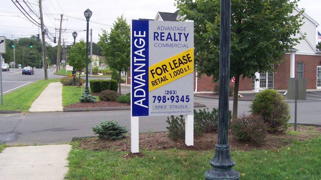Real estate sign placed in front of a residential property