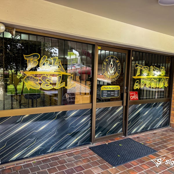 Sailtrack banner and custom window graphics created and installed by Signarama Springwood for Dog House Collectables storefront signage