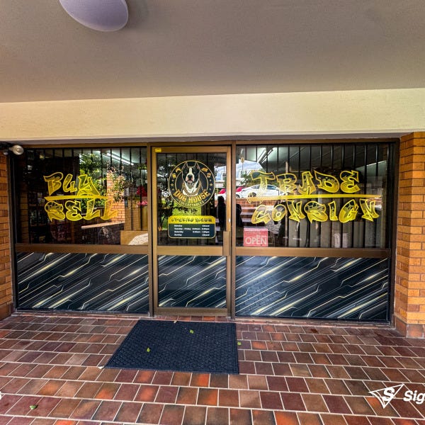 Sailtrack banner and custom window graphics created and installed by Signarama Springwood for Dog House Collectables storefront signage