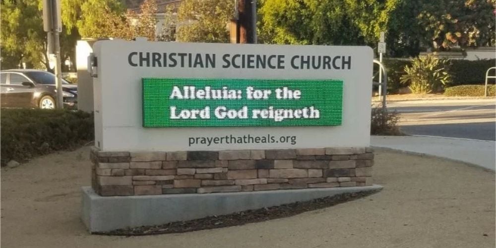 Multilingual signs, featuring an outdoor Christian Science Church monument sign with an interchangeable letter board.