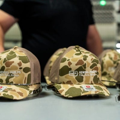 https://cdn.gorilladash.com/images/media/21453335/fully-promoted-usa-custom-embroidered-hensel-phelps-camo-hats-fully-promotedjpg-square-6a340fe895e9e.jpg?auto=webp&crop=1%3A1%2Csmart&width=400