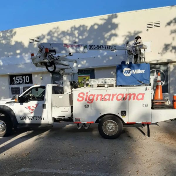 bucket truck in front of steven kessler motor cars