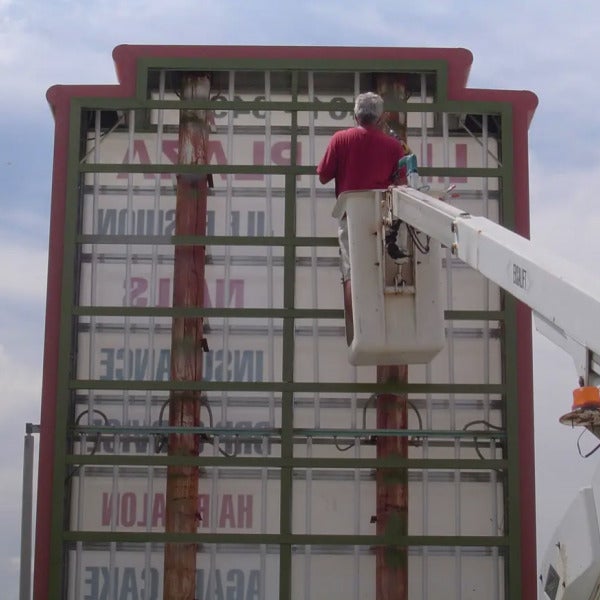 roger installing plaza sign