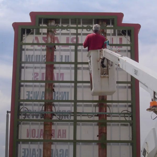 roger installing plaza sign