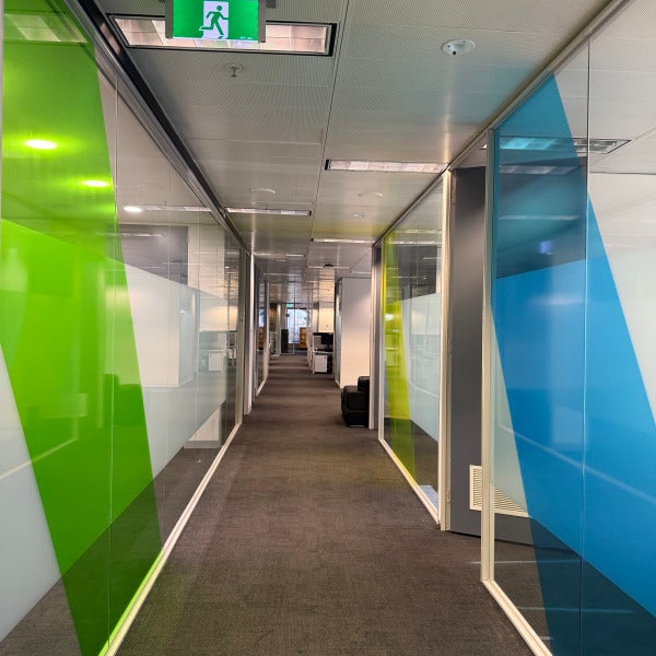Custom colour translucent and frosted vinyl graphics installed on glass throughout the MTData office corridor, providing privacy, branding, and a modern professional finish.