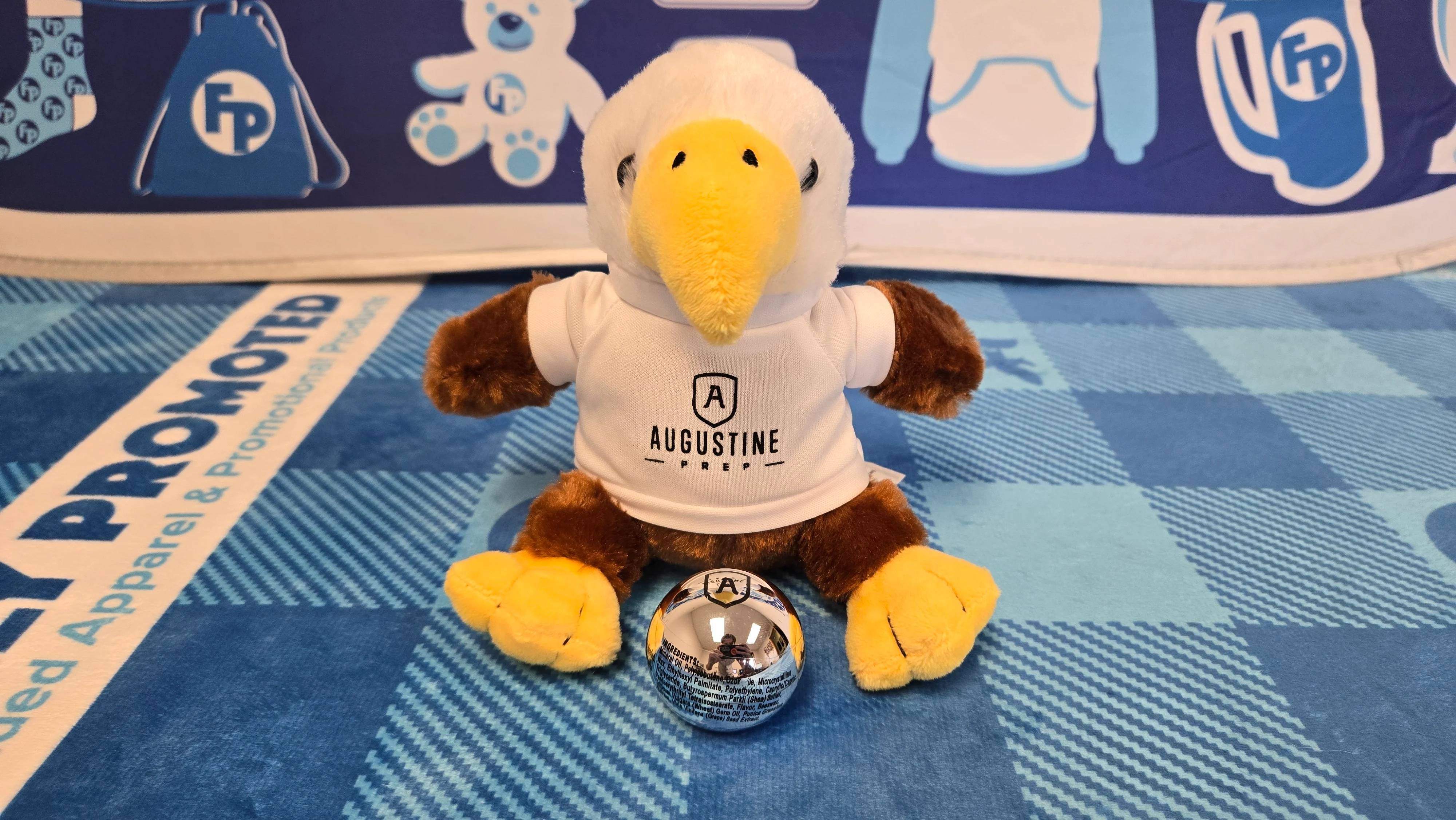 A Branded Plush Eagle and Lip Balm Ball for Augustine Prep