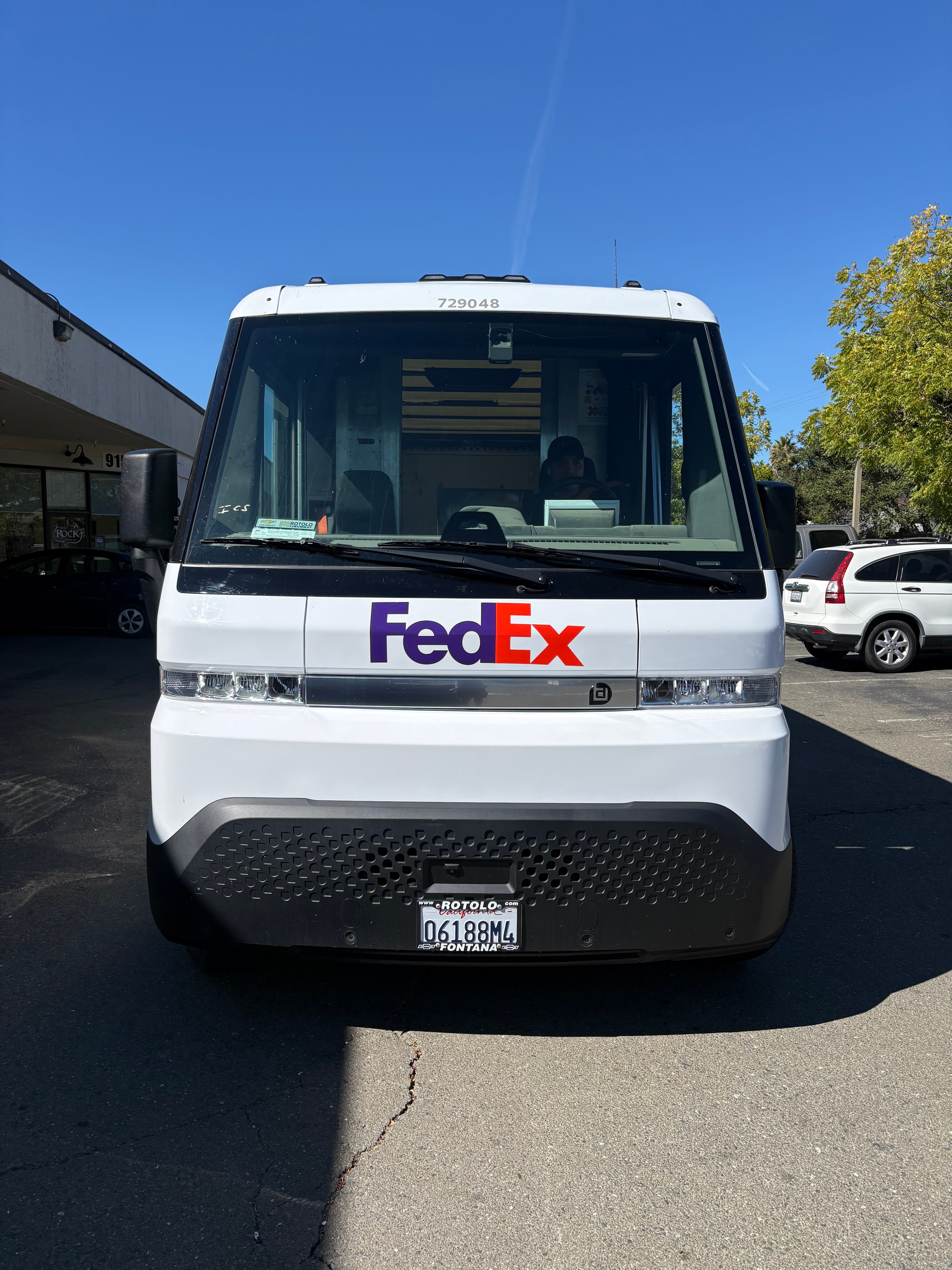 Front view of a white FedEx BrightDrop electric delivery van with the FedEx logo.