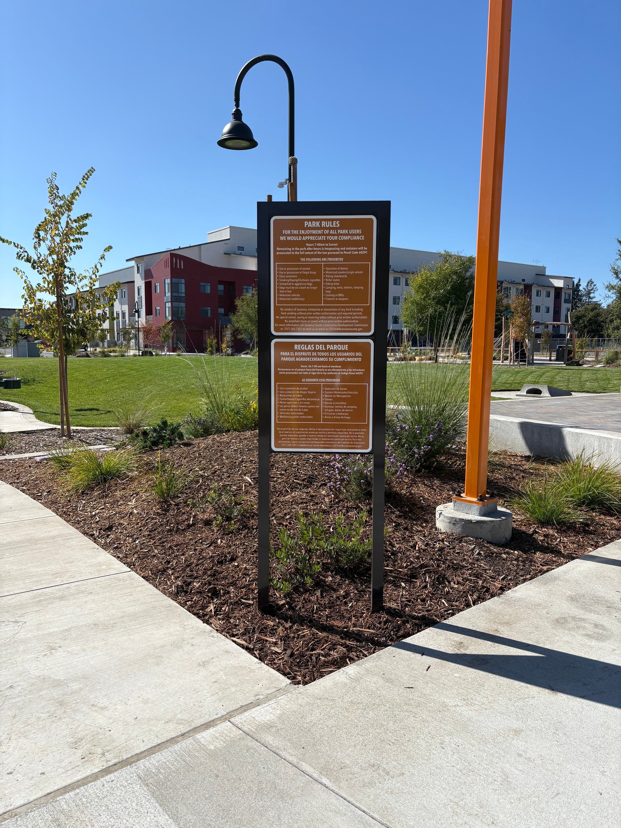 English and Spanish park rules sign at Plaza Permanente in Santa Rosa