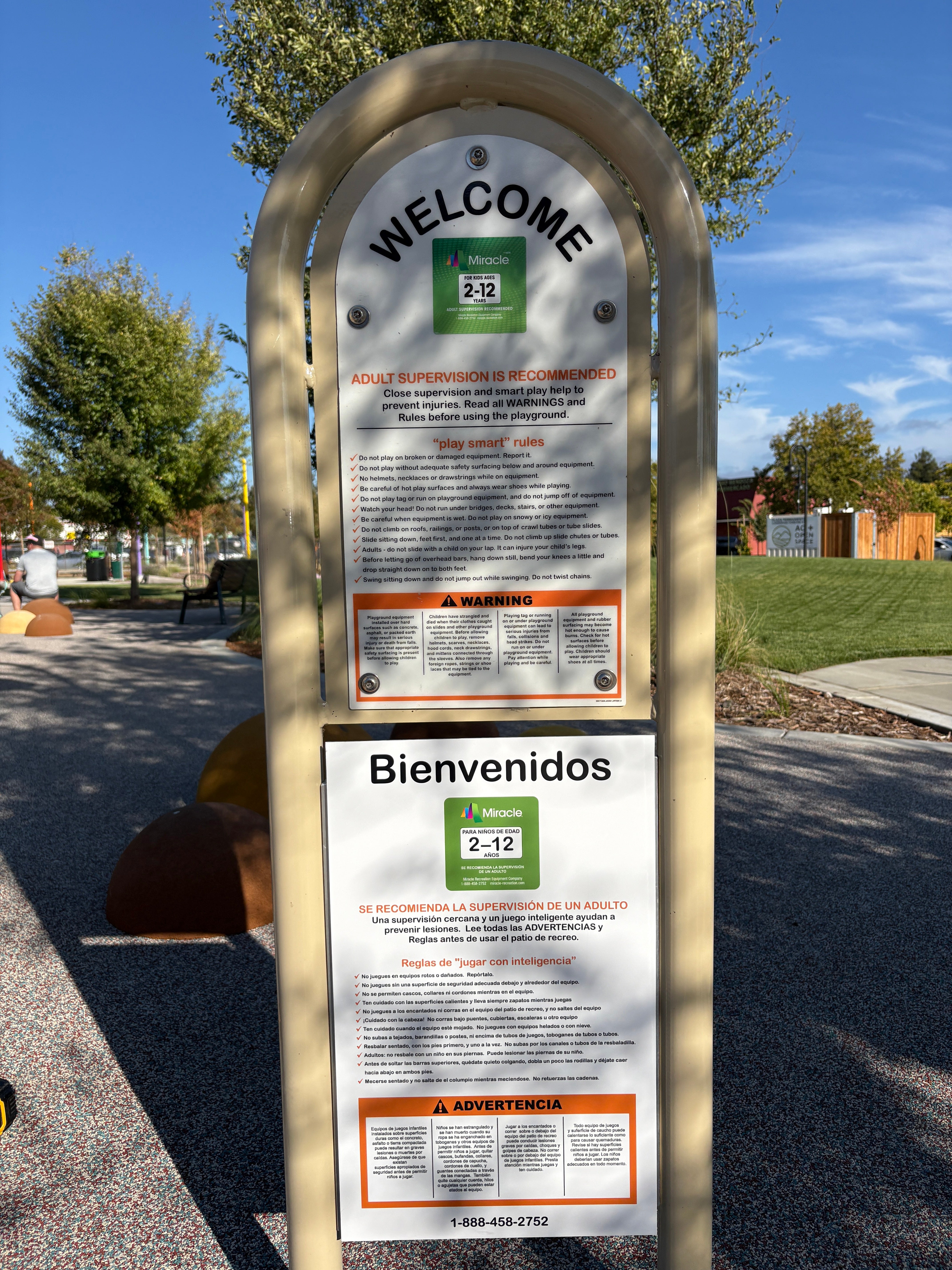 Bilingual English and Spanish playground safety rules sign at Plaza Permanente in Santa Rosa