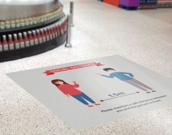 Floor graphic asking customers to stay 1.5m apart