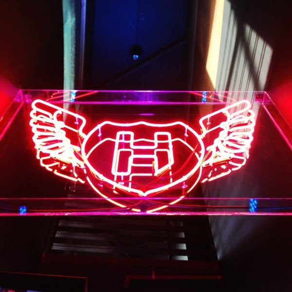 Red neon sign above a nightclub entrance | Neon Signs