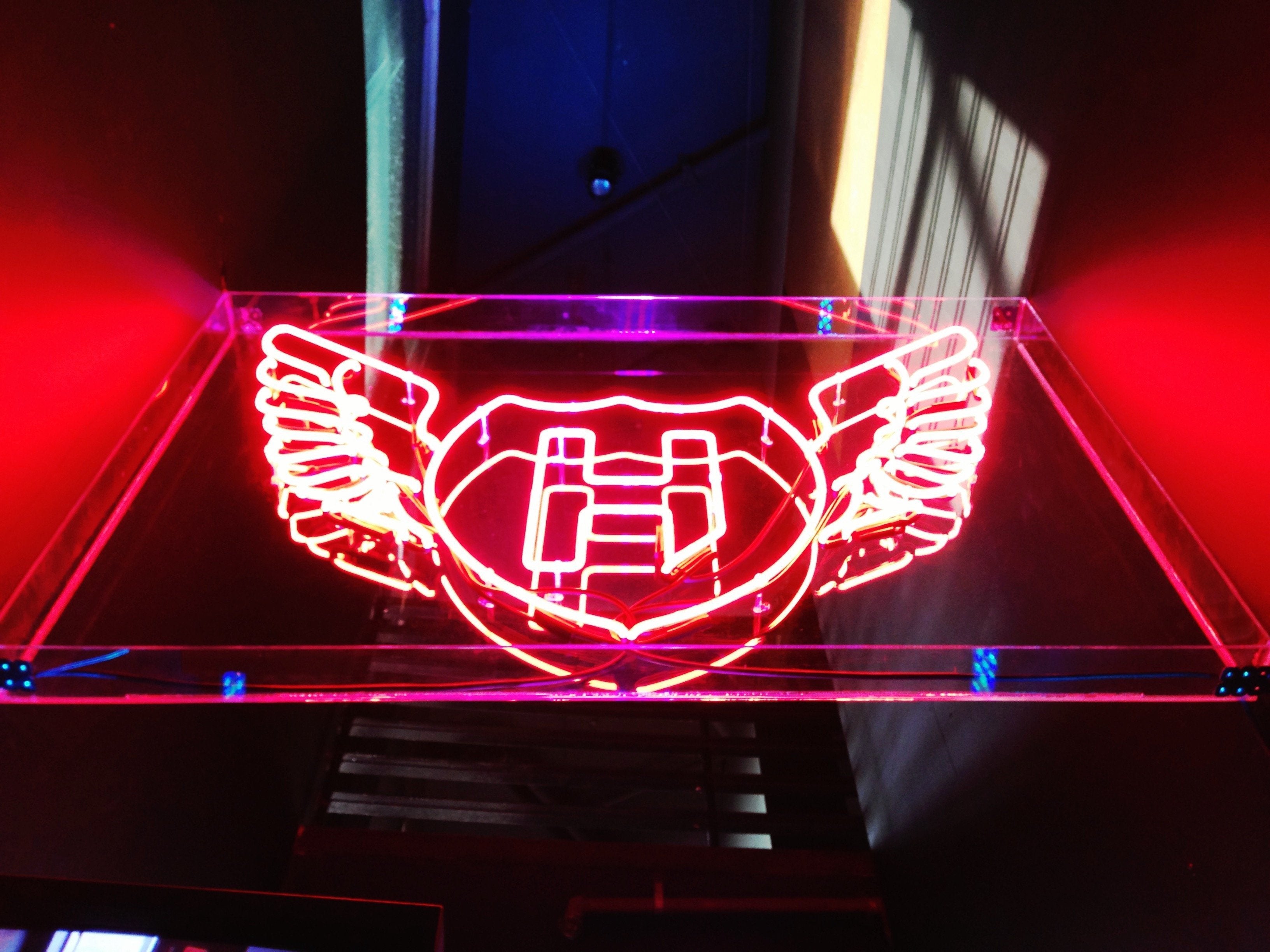 Red neon sign above a nightclub entrance | Neon Signs