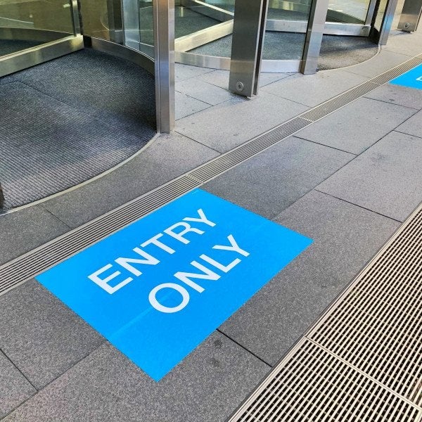 A bright blue entry only floor graphic in the city