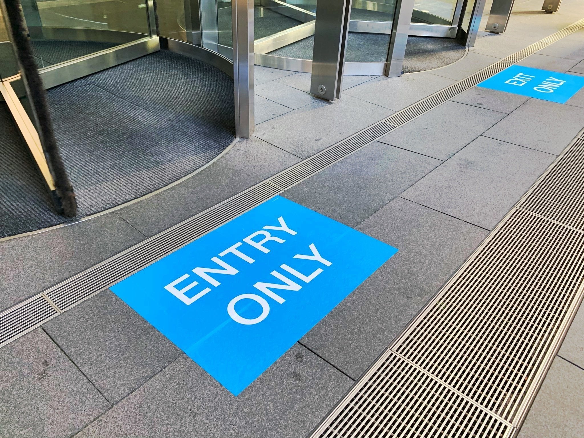 A bright blue entry only floor graphic in the city