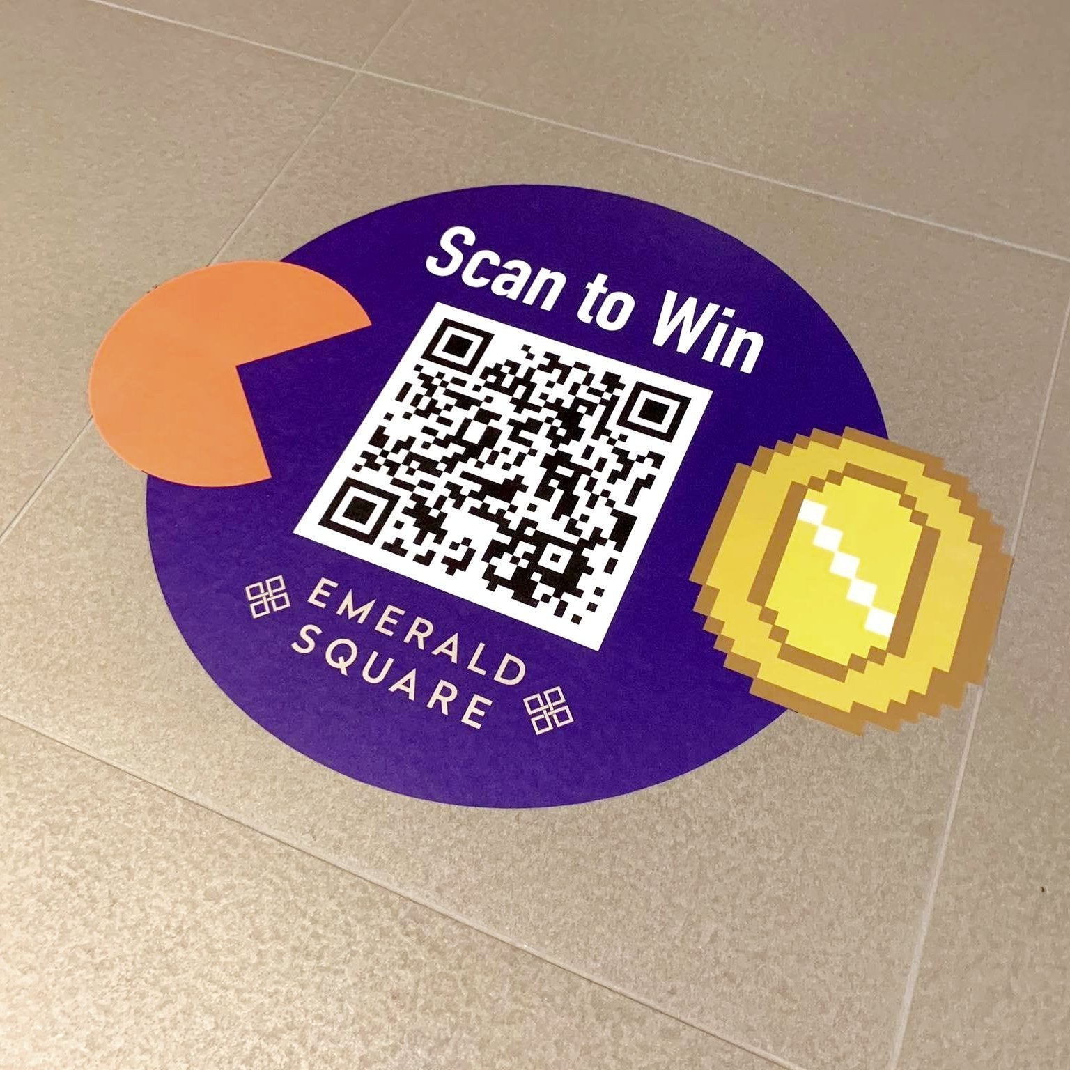 A fun floor graphics which shows a pac man character chasing a coin with a large qr code im the centre