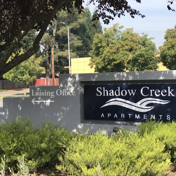 Shadow Creek Apartments monument sign beside landscaping
