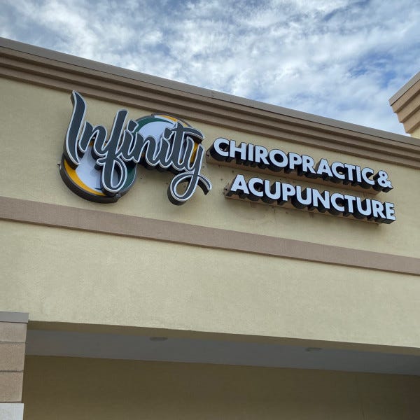 Lighted storefront sign channel letters on raceway