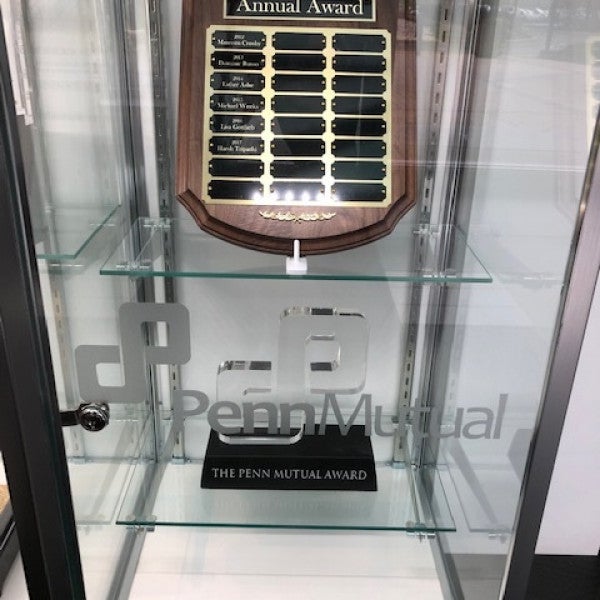 Penn Mutual recognition plaque displayed in a glass case